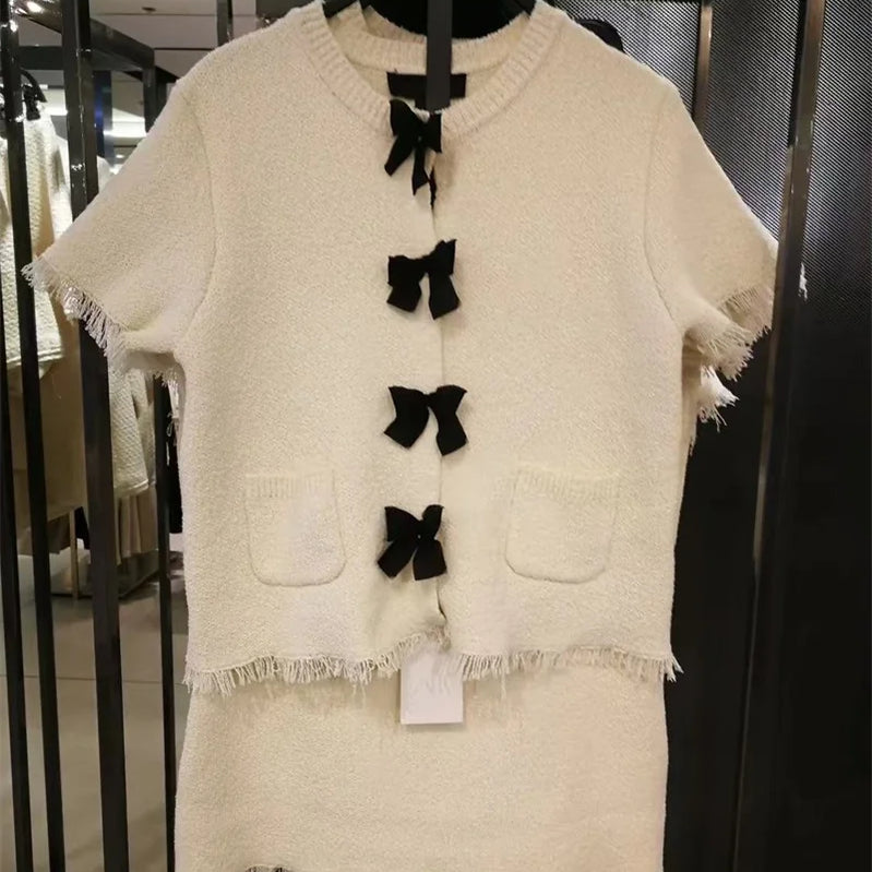 Women's suit Spring 2025 Black bow trim White knitted long-sleeved jacket Mini skirt Celebrity style Elegant