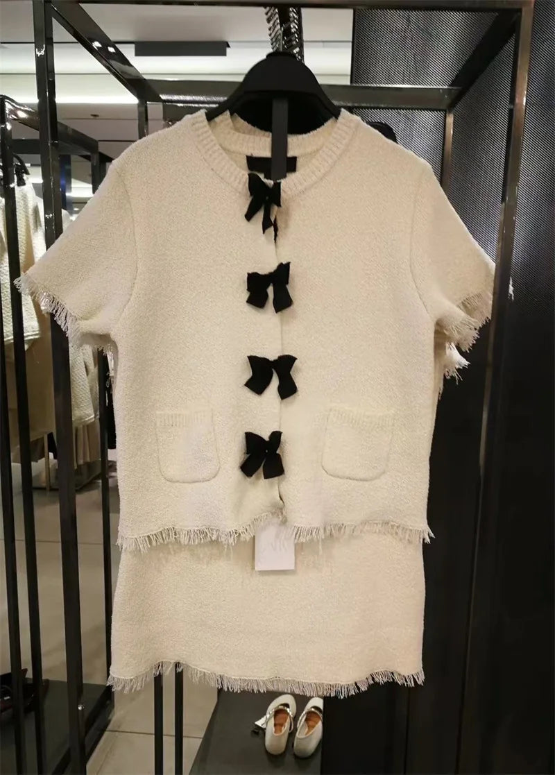 Women's suit Spring 2025 Black bow trim White knitted long-sleeved jacket Mini skirt Celebrity style Elegant